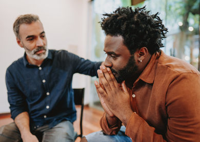 An adviser comforting a member of staff who has been made redundant.