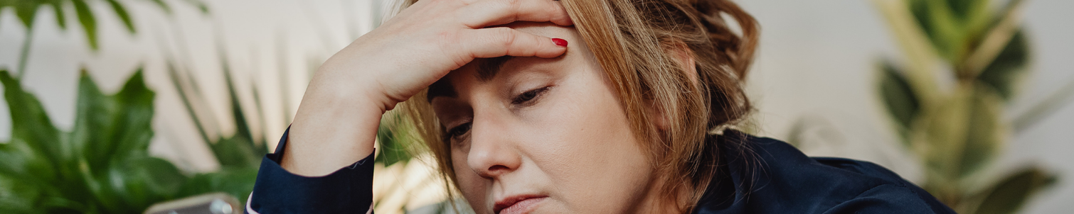 Female sitting at home looking stressed