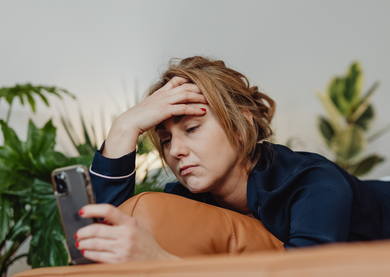 Female sitting at home looking stressed
